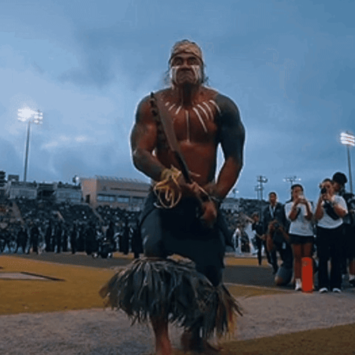 Man in Native American Costume Standing on Field