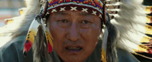 Man In Native American Headdress And Feathers GIF