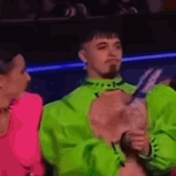 Man In Neon Green Jacket Next To Woman GIF