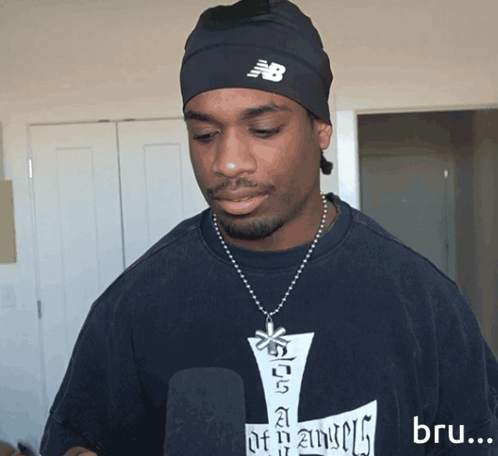 Man in New Balance Beanie and Blue Shirt
