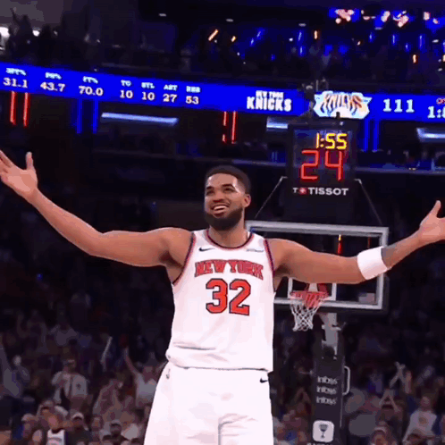 Man in New York Knicks Jersey in Front of Scoreboard