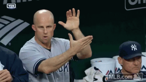 Man in New York Yankees Jersey Raising Hands