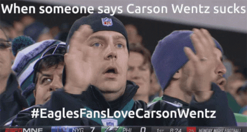 Man in NFL Hat Stands in Crowd