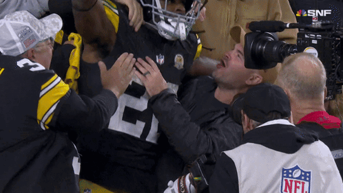 Man In NFL Jacket Holding Football Player's Chest GIF
