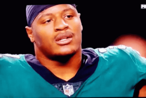 Man in NFL Jersey on TV Screen