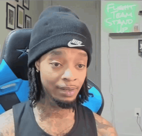 Man In Nike Beanie Sitting In Chair GIF