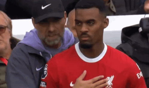Man in Nike Hat Next to Man in Red Shirt