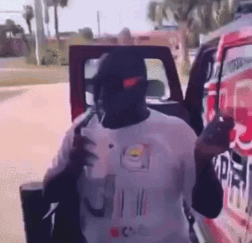 Man in Nike Hat Standing by Red Truck