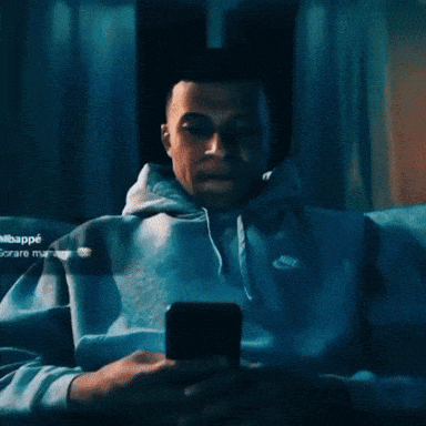 Man In Nike Hoodie Looking Up At Camera GIF