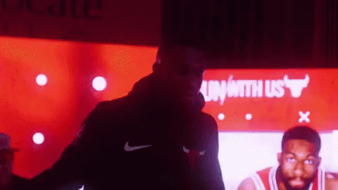 Man In Nike Jacket By Bulls Sign GIF