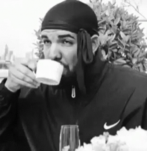 Man in Nike Jacket Drinking Cup