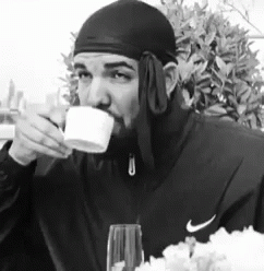 Man in Nike Jacket Drinking from Cup