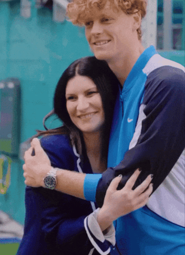 Man In Nike Jacket Hugging Woman In Blue Jacket GIF