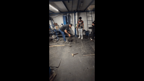 Man in Nike Shirt Kneeling in Garage