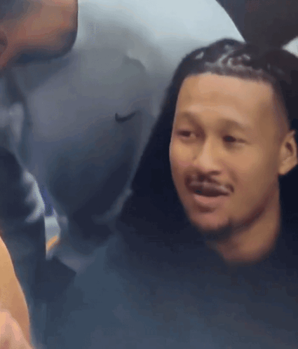 Man in Nike Shirt Looking at Another Man