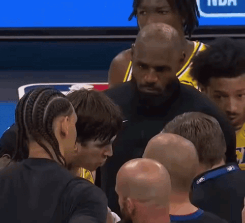 Man in Nike Shirt Talking to Men