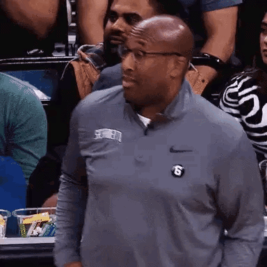 Man in Nike Shirt with Letter S in Crowd