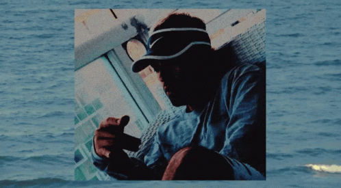 Man in Nike Visor Sitting by Water