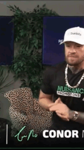 Man in Nuisanc T-Shirt Sitting