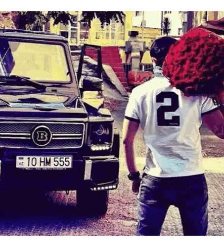 Man in Number 2 Shirt Holding Roses
