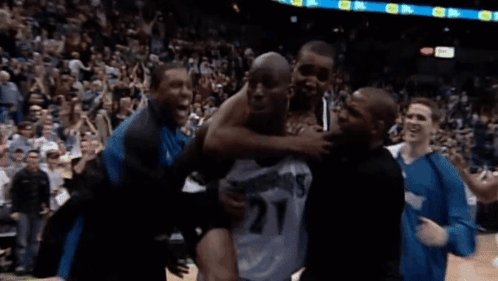 Man In Number 27 Jersey Lifted By Group Of Men GIF