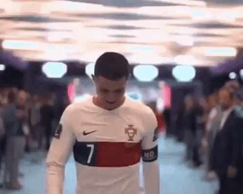 Man in Number 7 Soccer Jersey Walking Through Crowd