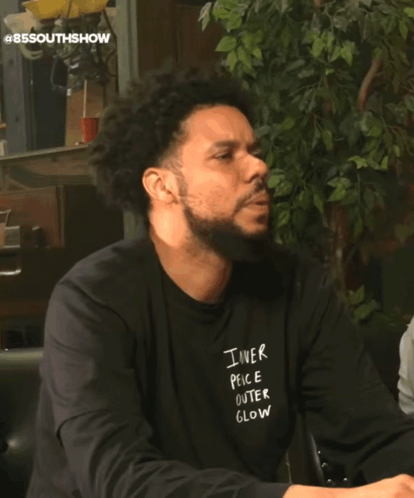 Man In Number 85 Jersey Sitting On Couch Next To Another Man GIF