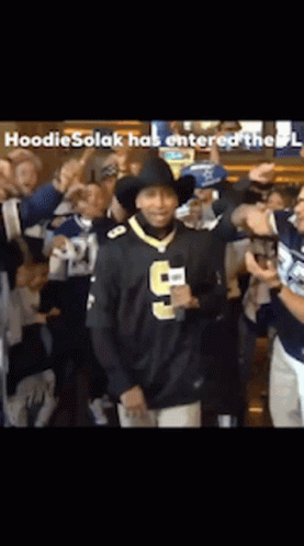 Man in Number 9 Jersey Surrounded by People