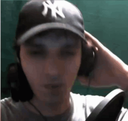 Man in NY Hat and Headphones