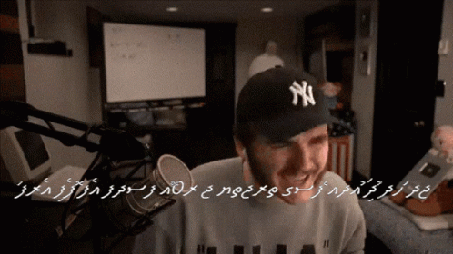 Man in NY Hat at Microphone