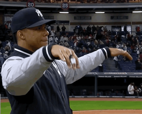Man in NY Hat on Baseball Field with Crowd