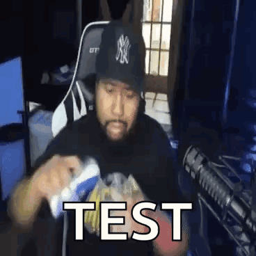 Man in NY Yankees Hat Holding Video Game Controller