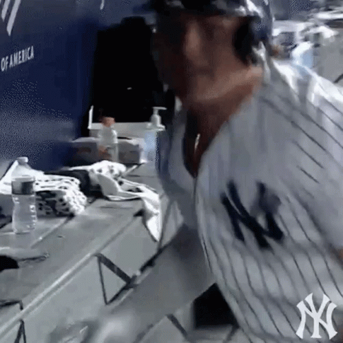 Man in NY Yankees Jersey Standing in Locker Room