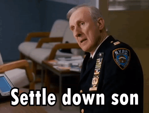 Man in NYPD Uniform Sitting at Table