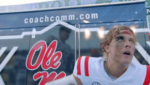 Man in Ole Miss Jersey in Front of Coachcomm Truck