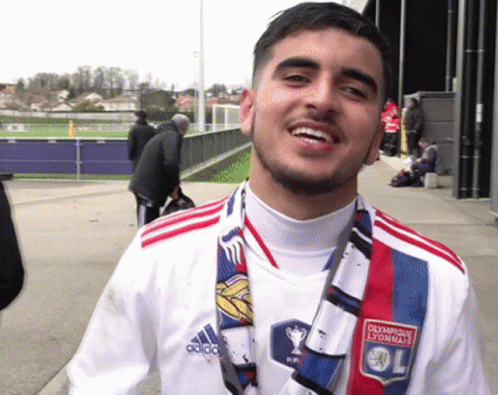 Man in Olympique Lyonnais Shirt and Scarf Smiling