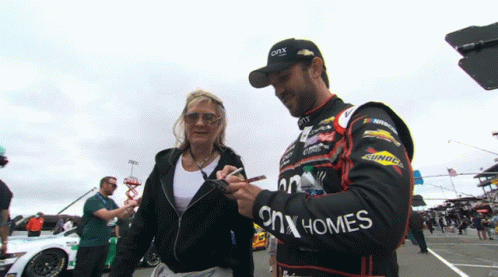 Man in ONX Homes Jacket Signing Woman's Hand