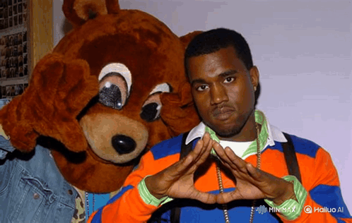 Man in Orange and Blue Sweater Next to Teddy Bear