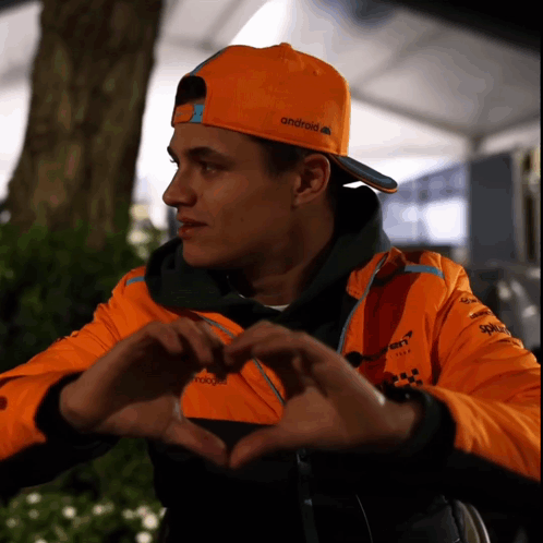 Man In Orange Android Hat Making Heart GIF