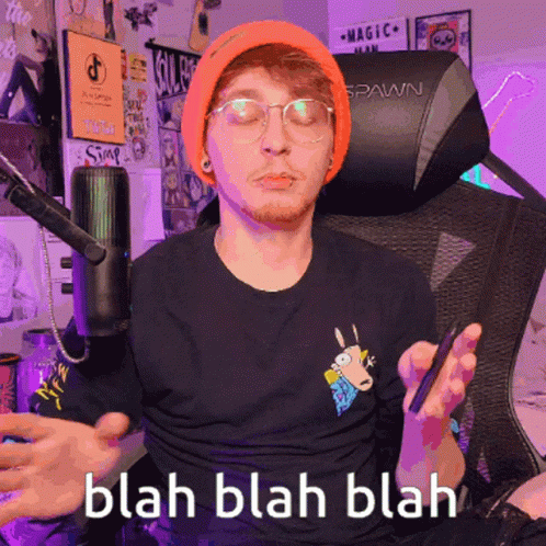 Man In Orange Beanie And Glasses Sitting In Spawn Chair GIF