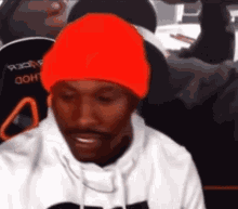 Man in Orange Beanie Sitting
