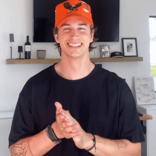 Man in Orange Hat With Eagle Clapping Hands