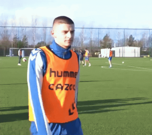 Man in Orange Hummel Cazoe Vest