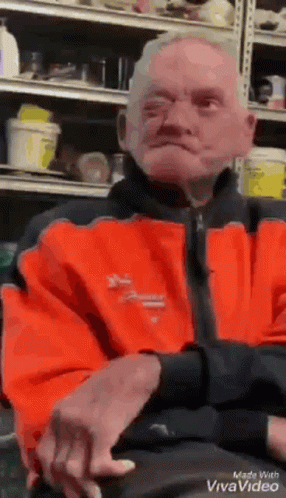 Man in Orange Jacket Sitting