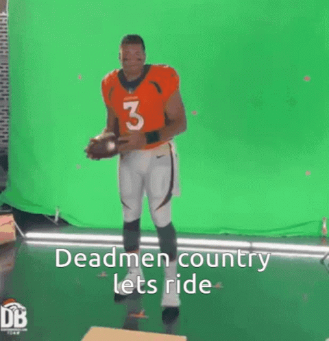 Man in Orange Jersey Holding Football