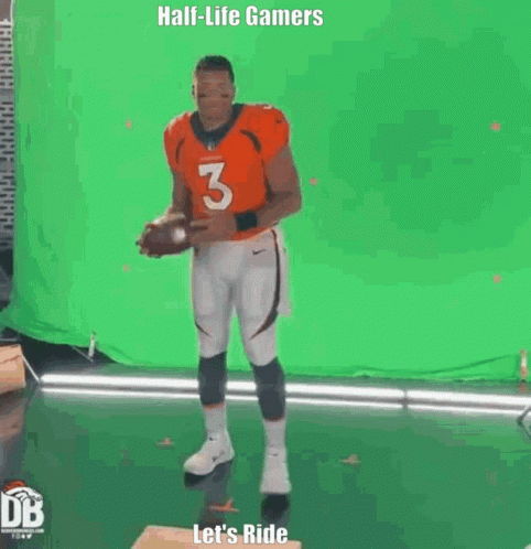 Man in Orange Jersey Holding Football