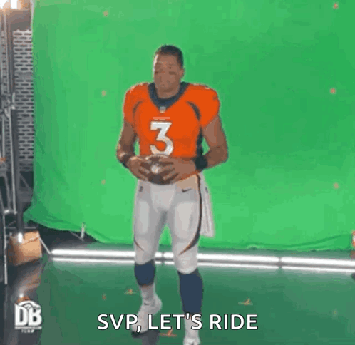 Man in Orange Jersey Holding Football
