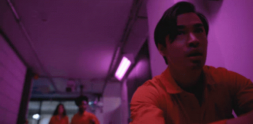 Man in Orange Jumpsuit Running Down Hallway