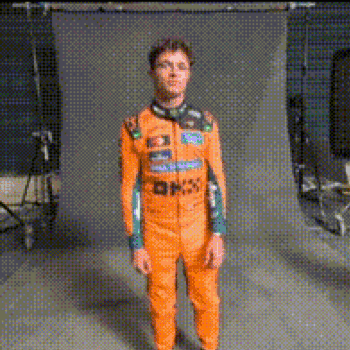 Man in Orange Jumpsuit Standing in Front of Wall