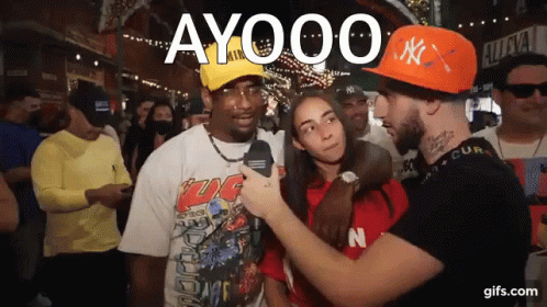 Man in Orange NY Hat Talking to Woman